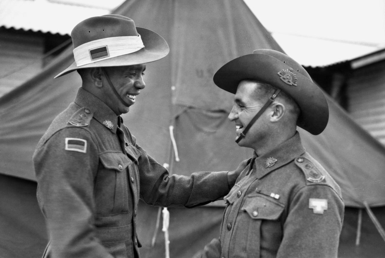 Lieutenant Reg Saunders (left) and Lieutenant Tom Derrick VC DCM, congratulate each other following their graduation from the Office Cadet Training Unit at Seymour, 25 November 1944.