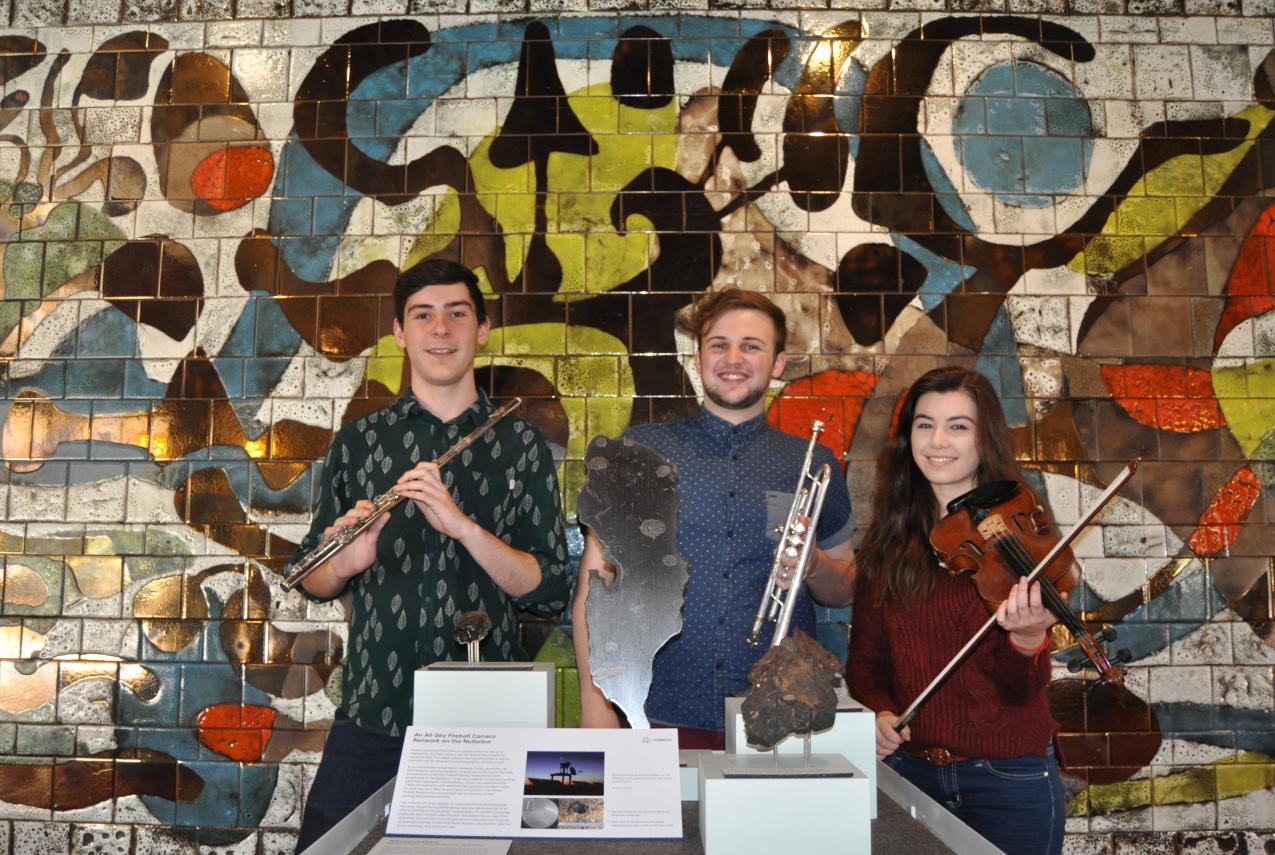 Jonty Coy, Fletcher Cox and Louise May pose around the meteorite display