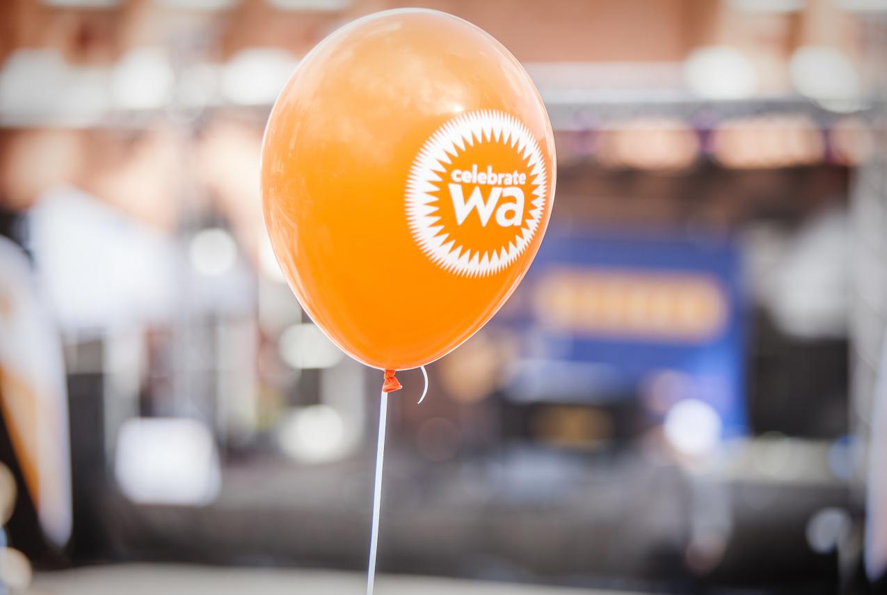 An orange balloon with Celebrate WA written on it