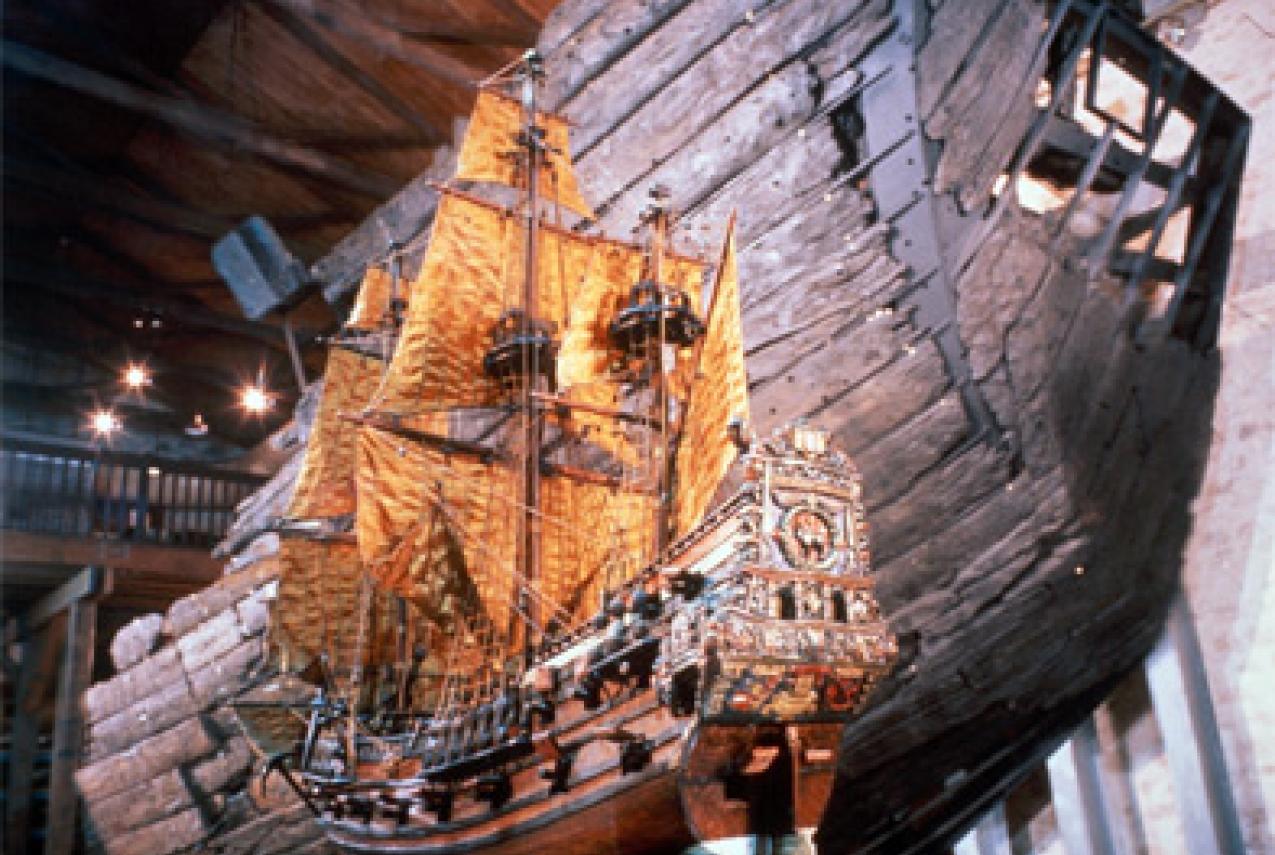 A large model of a ship next to the restored hull of the original vessel