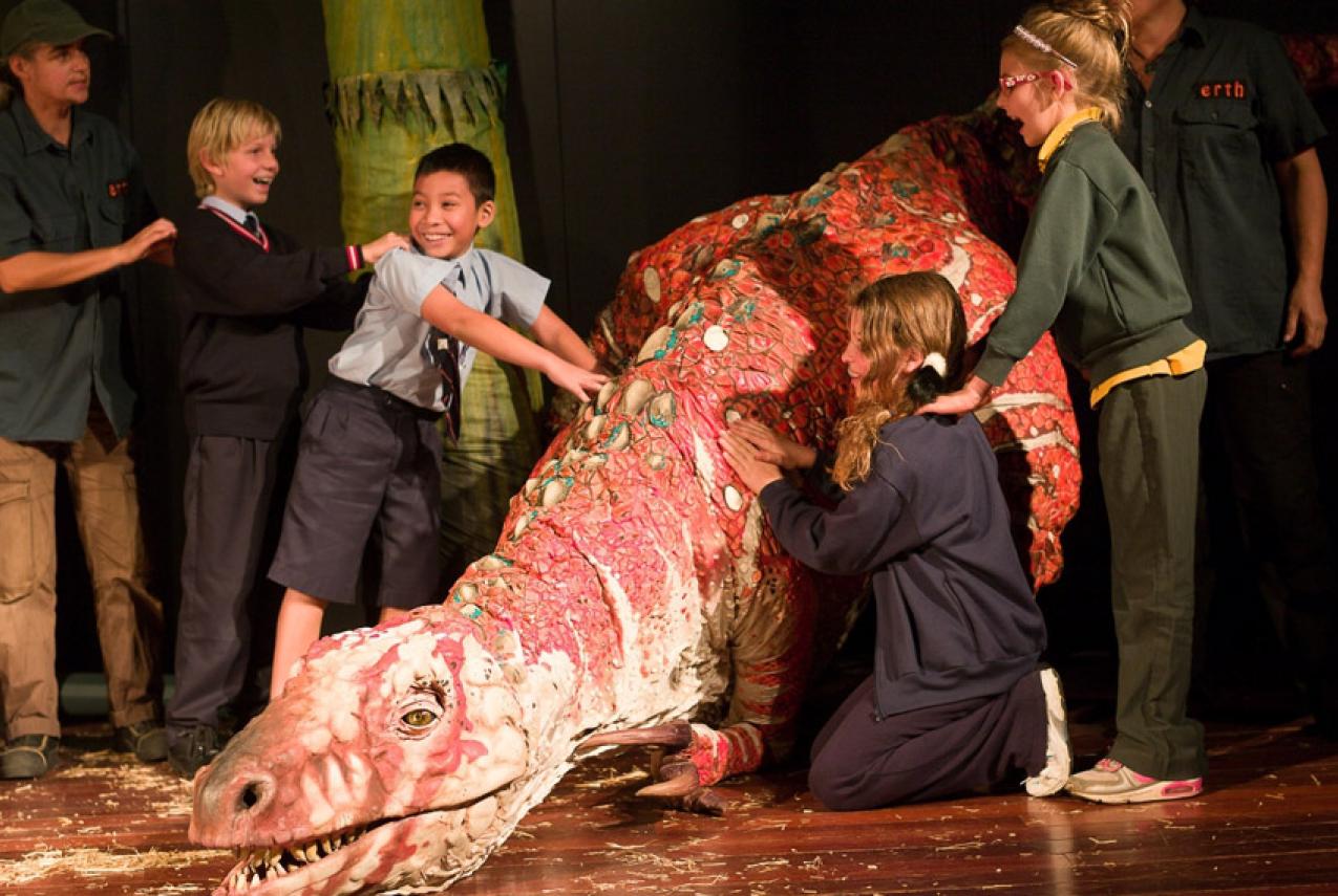 Children participating in the Erth Dinosaur Petting Zoo performance