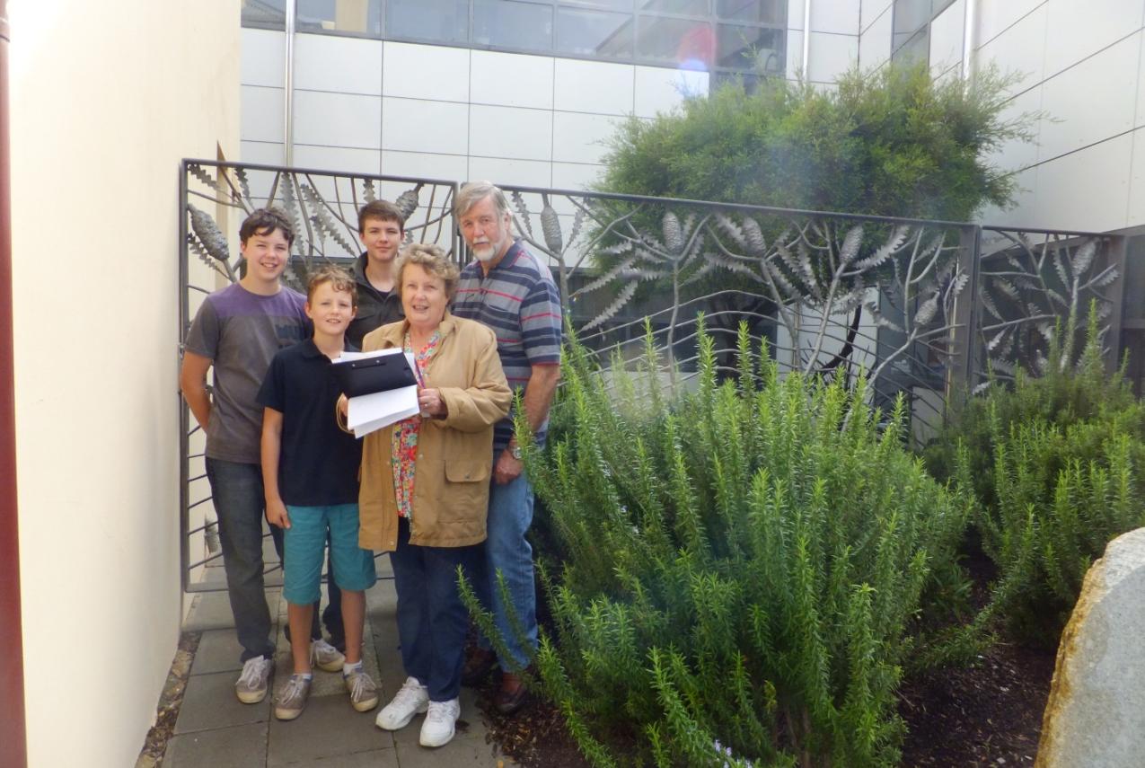 Five people walking through a heritage tour