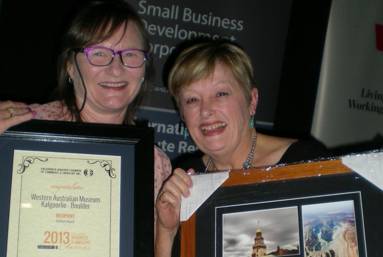 Two women from the WA Museum proudly displaying their awards