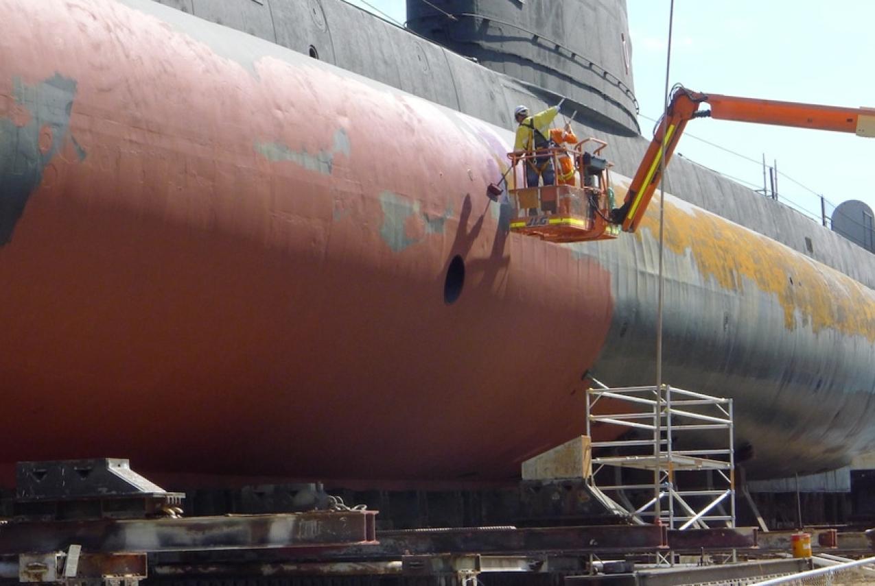 Conservation work being performed on a large submarine
