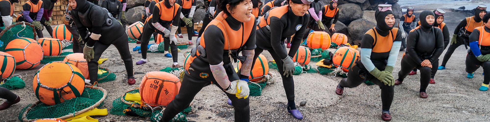 A group of female divers prepare to go into the ocean