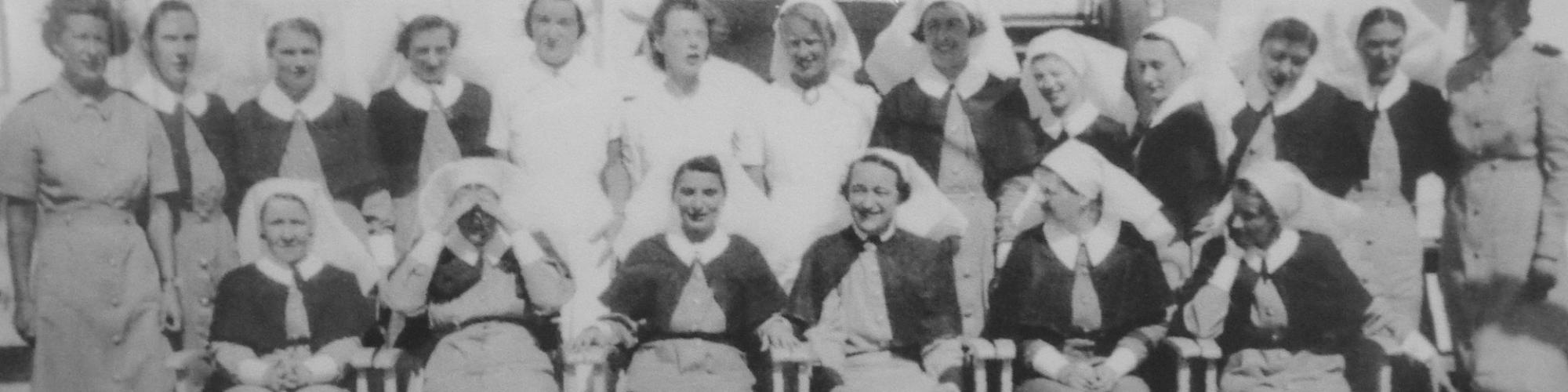 A black and white group photograph from the 1940s of nurses in uniform