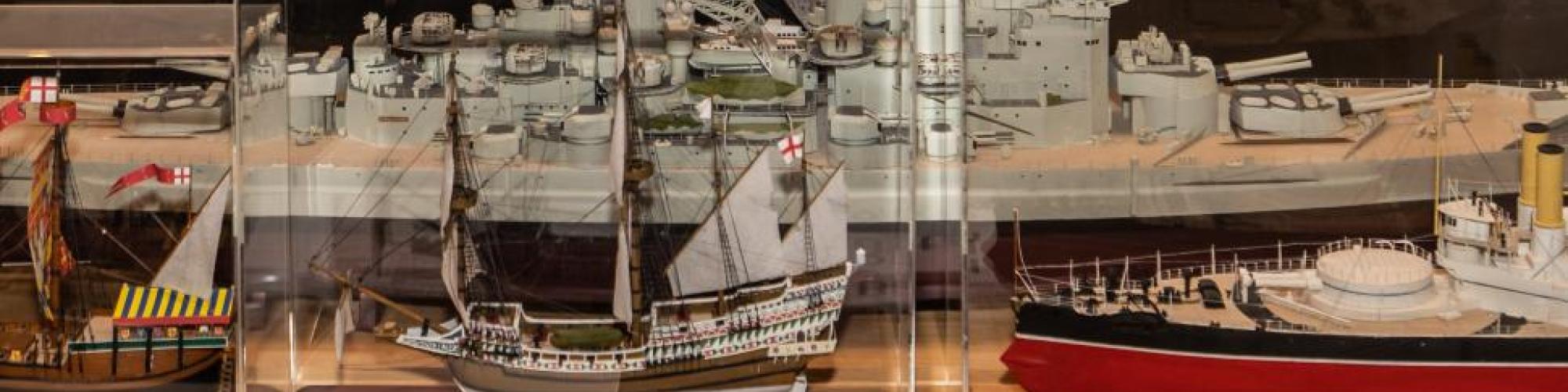 Gerry Westenberg with miniature ship model in glass case 