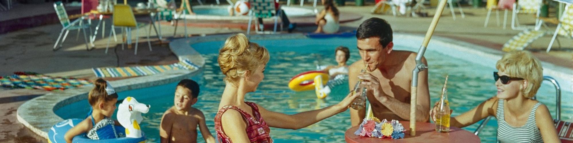 a scene of families lounging around a resort style pool 