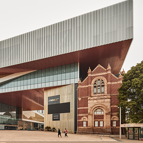 Two visitors walk towards the entrance of WA Museum Boola Bardip