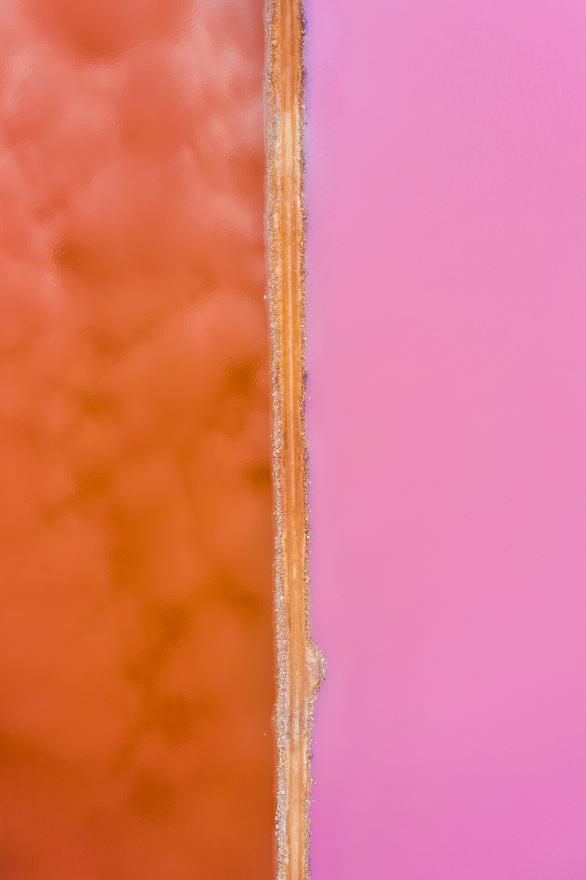 An aerial view of vibrant pink and red coloured lakes