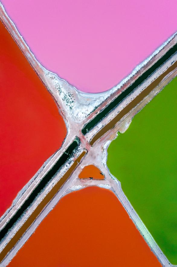 An aerial view showing the intersection of four brightly coloured lakes in shades of pink, red and green