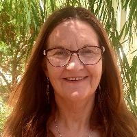 Dr. Helen Brown, a middle-aged brunette female, smiles looks into camera