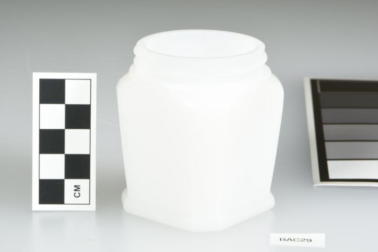 Opaque, white, screw-top jar, with octagonal design. 