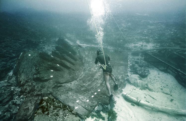 A diver photographs an underwater shipwreck