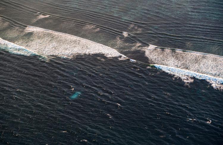An aerial photograph of ocean waves.