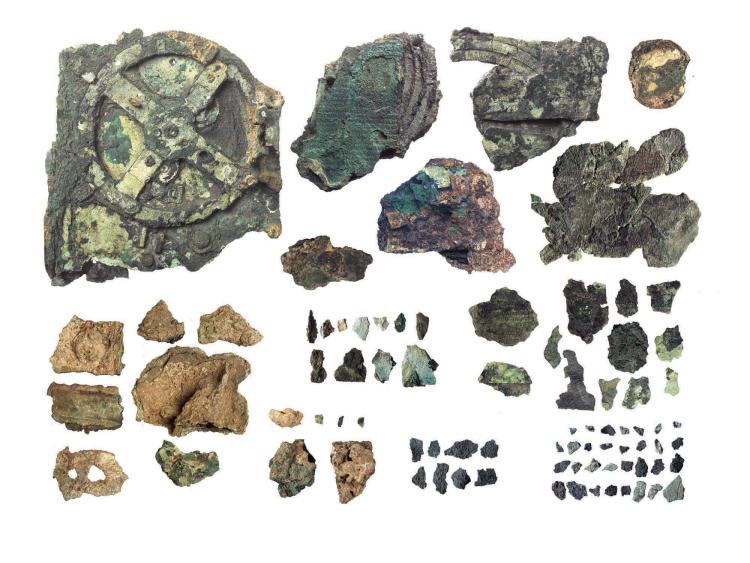 An image of 82 corroded bronze fragments of gears and archaeological material from the Antikythera mechanism