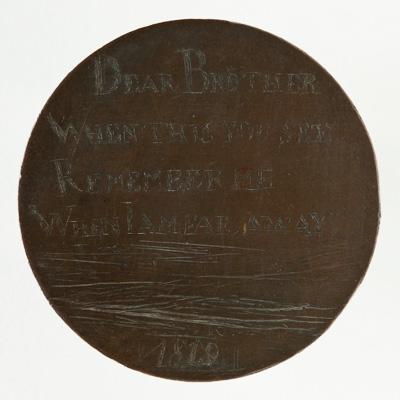 A small brown coin engraved by hand, with the words ‘Dear brother when this you see remember me when I am far away 1819’