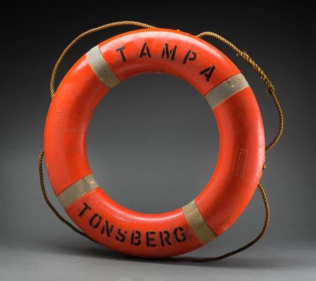 An orange lifebuoy with the words TAMPA TONSBERG in bold black lettering