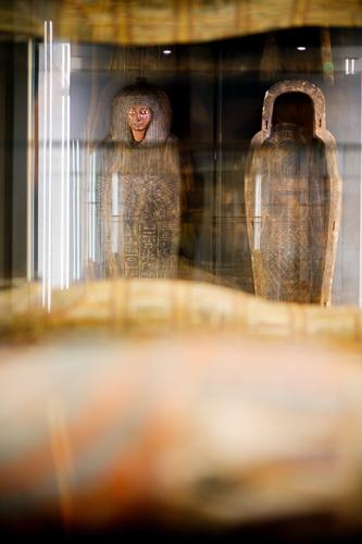 An image of the Outer Coffin of Panesy's coffin sets, depicting a brown coffin with a series of intricate carvings including a large winged goddess in the middle