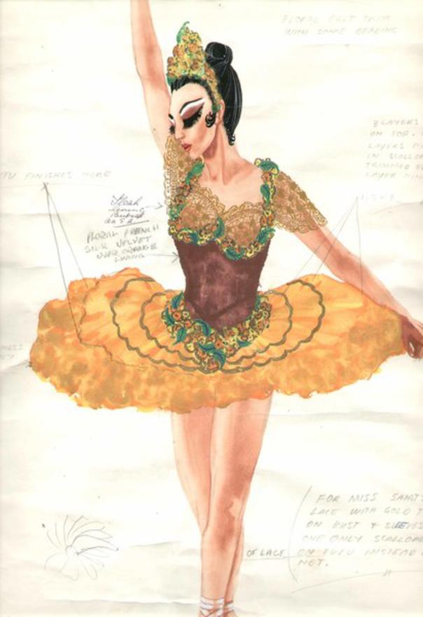A drawings of a ballerina wearing an orange tutu and crimson bodice with ornate yellow orange and green flowers and a matching crown. The drawing is covered in pencil annotations