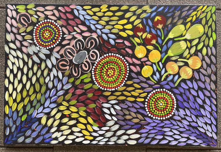 A colourful painting with a variety of multicoloured small petal-like strokes with small nuts and concentric circles.