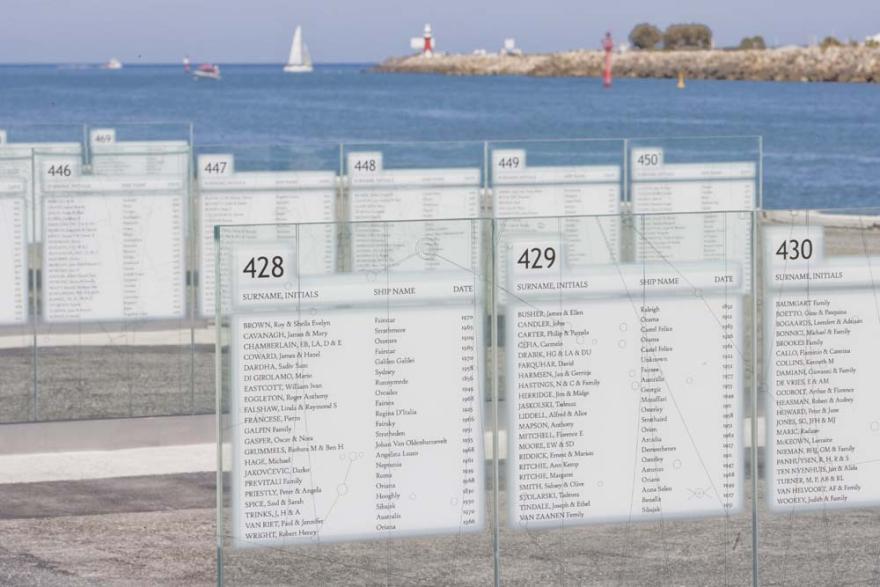Several rows of engraved glass panels with the names of people and ships and dates