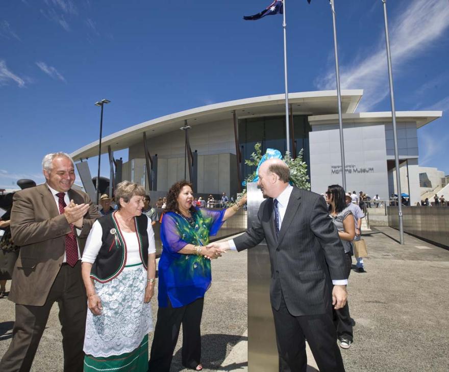 Four individuals interact in front of the Western Australian Maritime Museum.