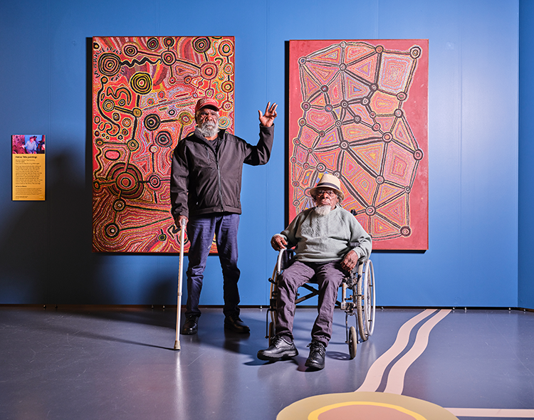 2 Spinifex artists standing in front of their artworks at WA Museum Boola Bardip