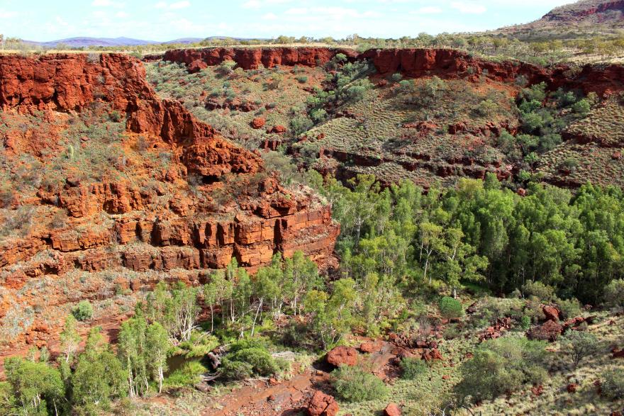 A sweeping landscape of red rock gorges and greenery