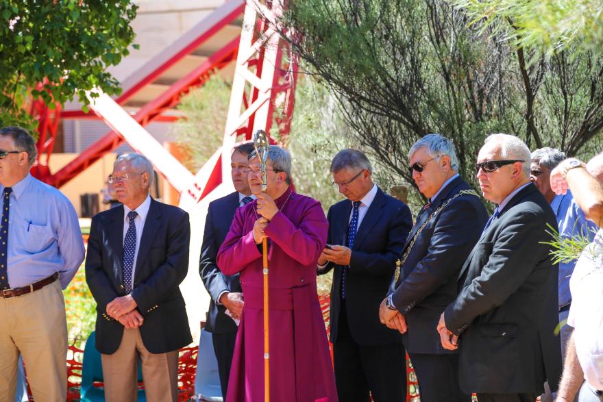 A group of people standing beside a memorial