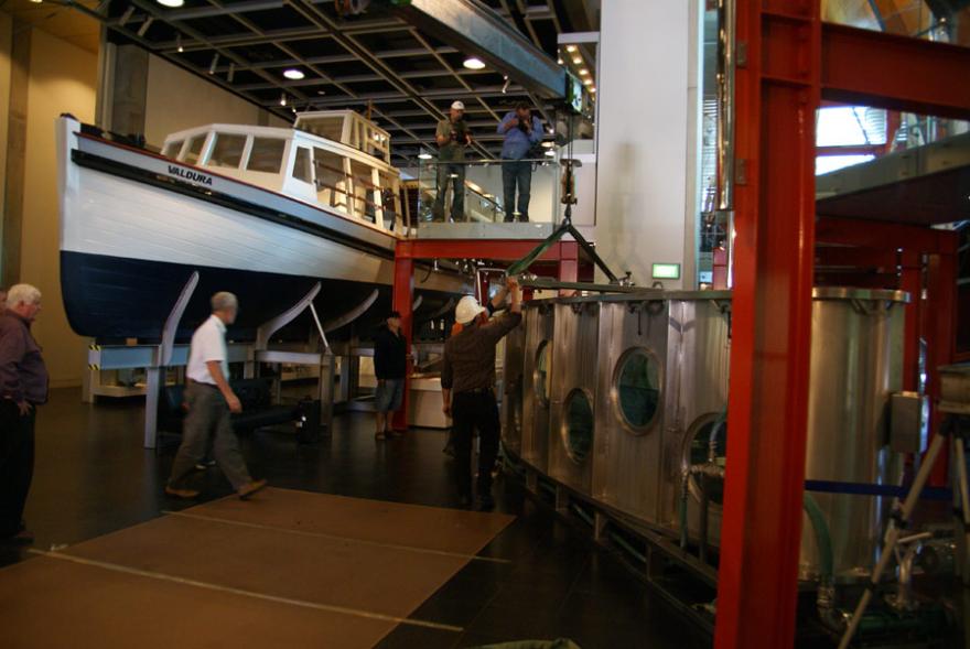 A custom-built shark tank located inside the WA Maritime Museum, next to boats and other maritime displays