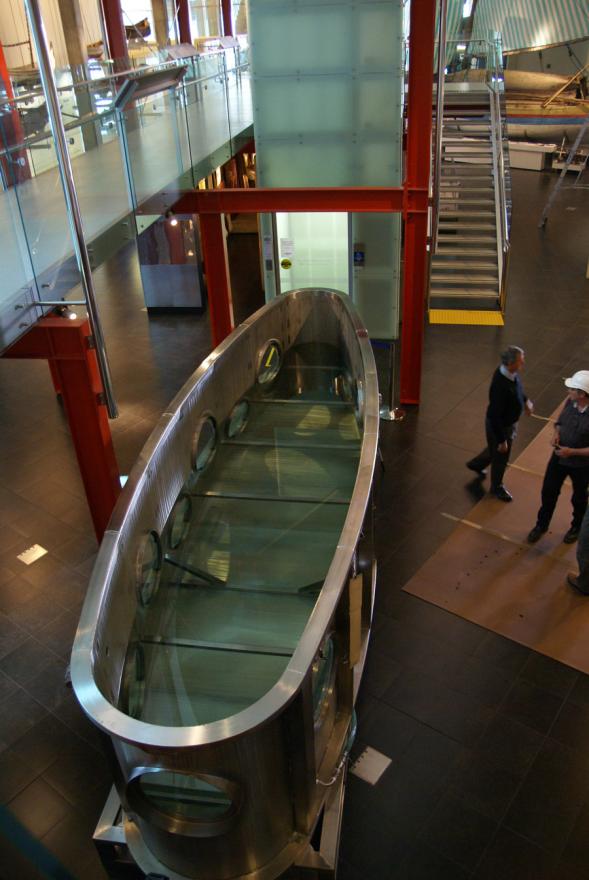 A custom-built shark tank located inside the WA Maritime Museum, next to boats and other maritime displays