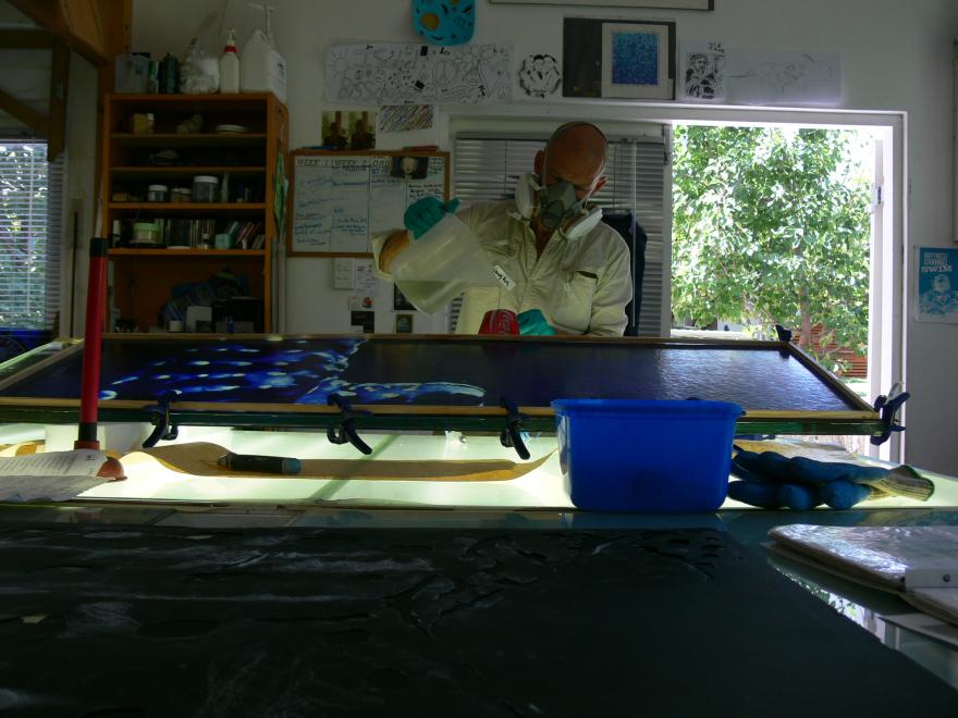 A person building the sculpture "Transparent Sea" in a glass workshop