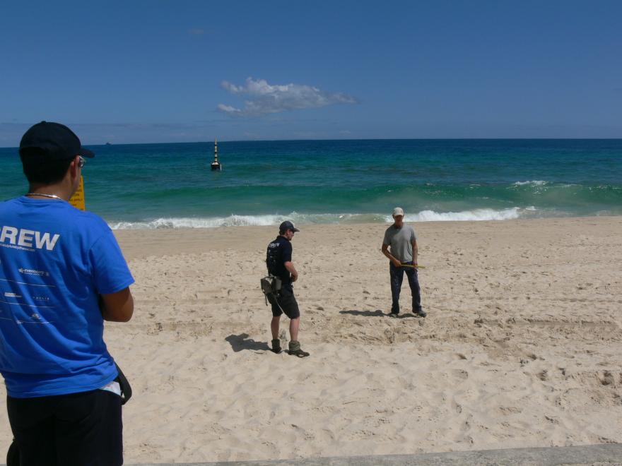 Installing a glass sculpture at a beach for display
