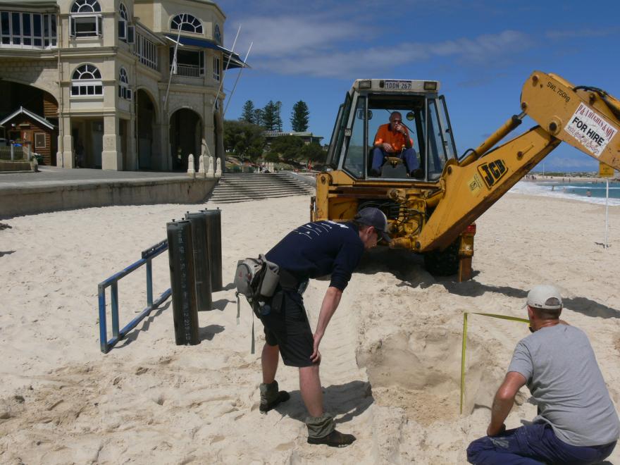 Installing a glass sculpture at a beach for display