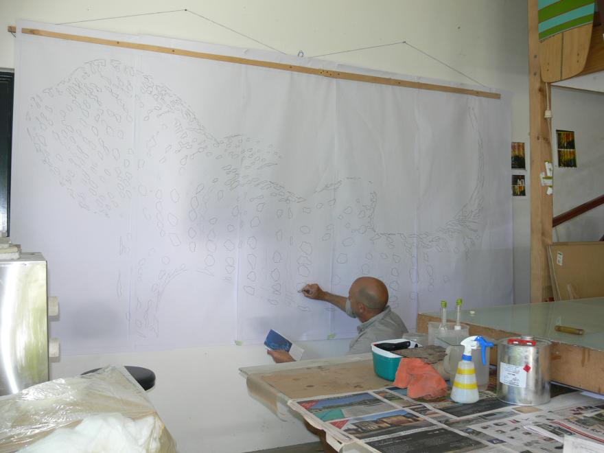 A person building the sculpture "Transparent Sea" in a glass workshop