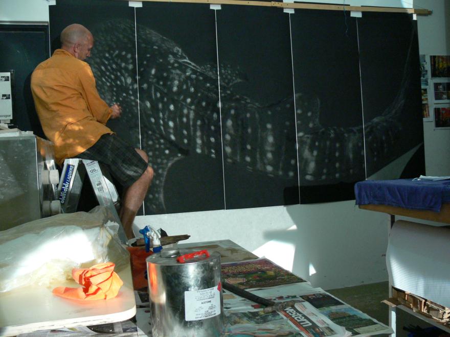 A person building the sculpture "Transparent Sea" in a glass workshop