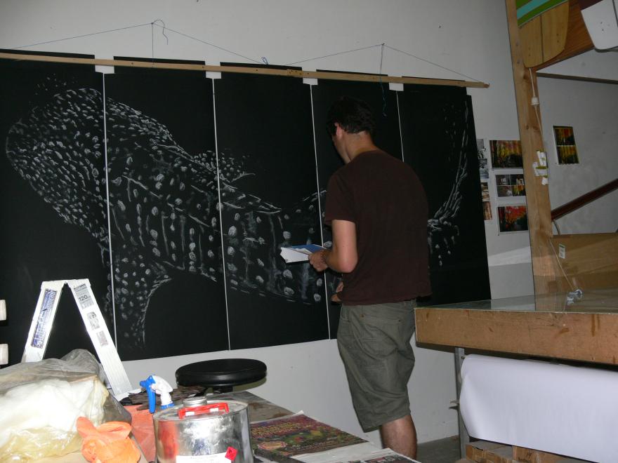 A person building the sculpture "Transparent Sea" in a glass workshop