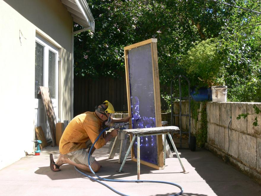 A person building the sculpture "Transparent Sea" in a glass workshop