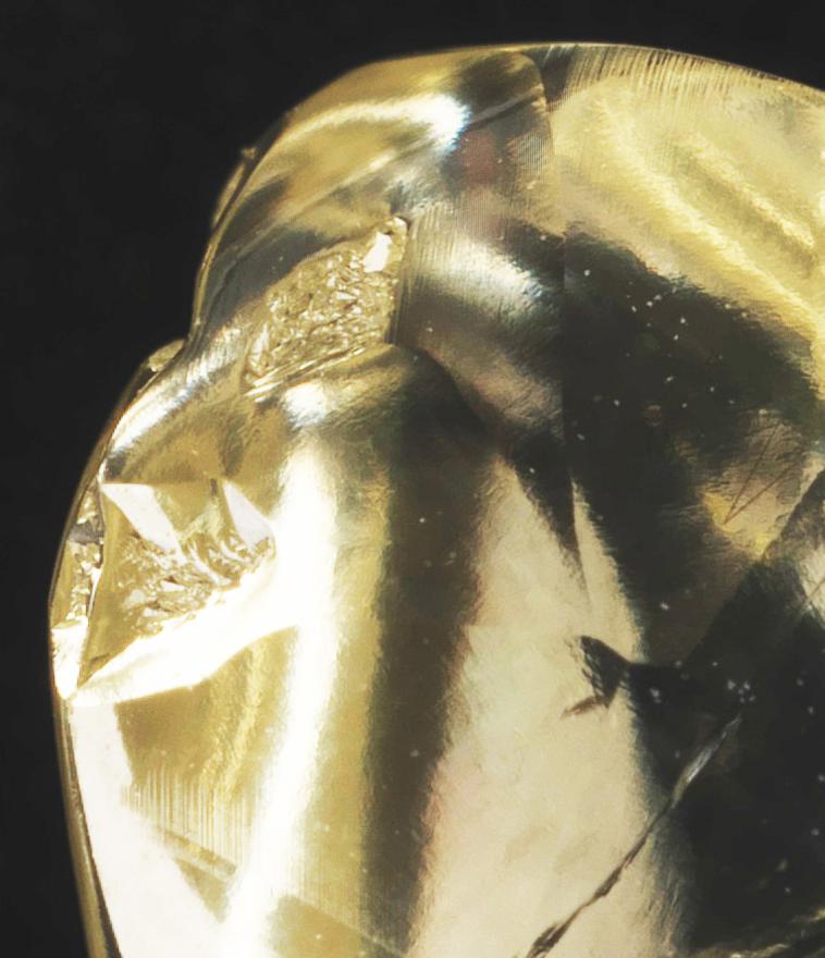 A yellow diamond on a black background