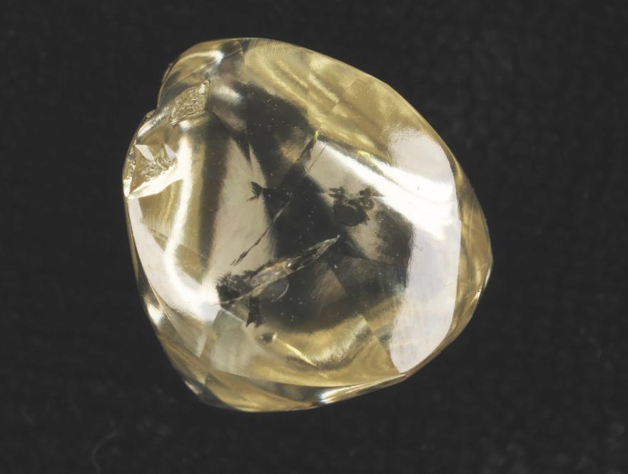 A yellow diamond on a black background