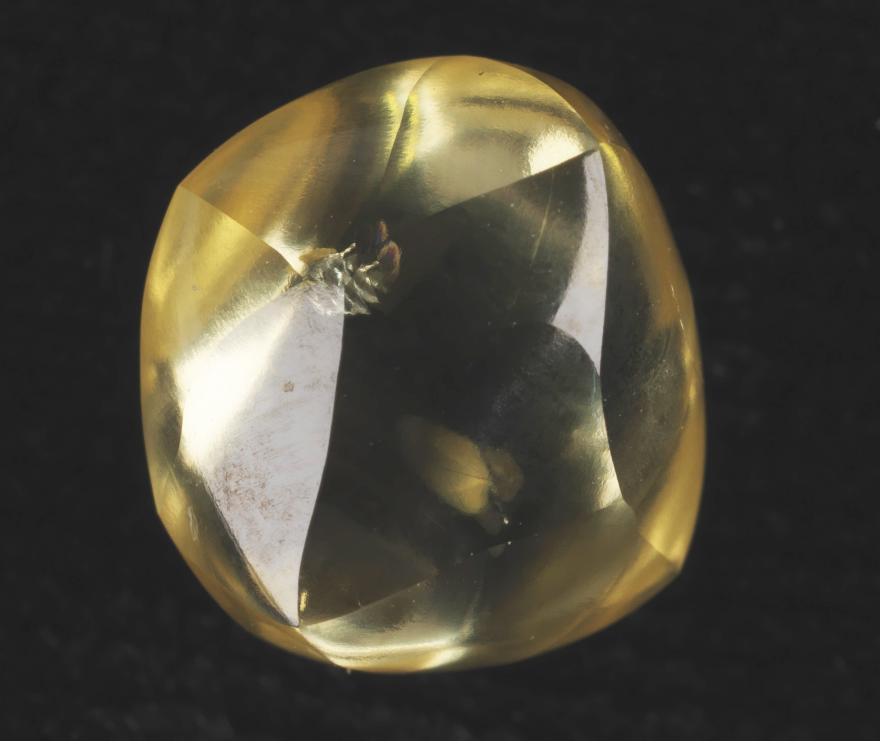 A yellow diamond on a black background