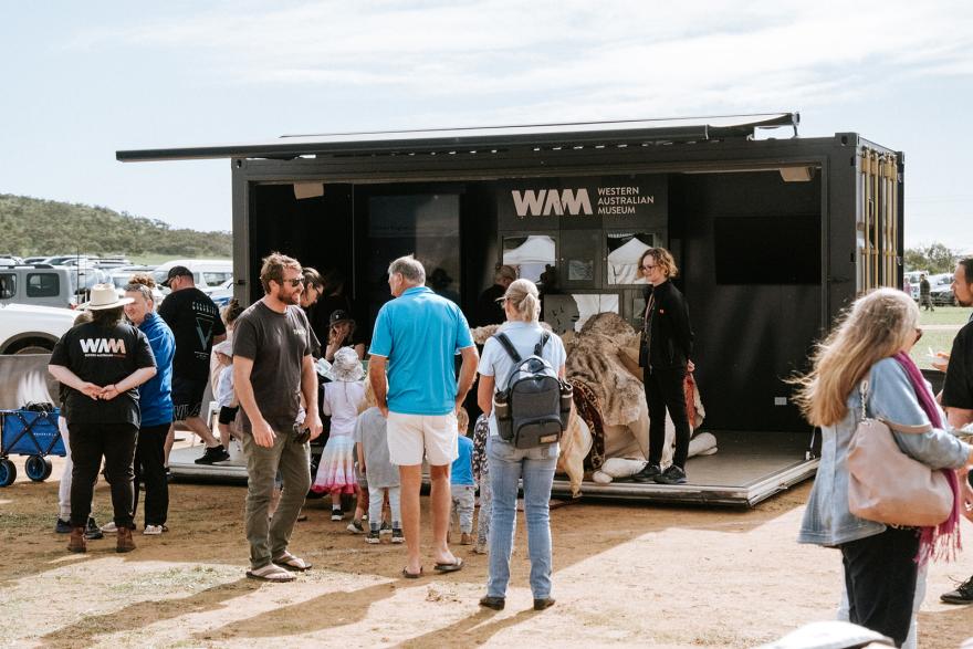 People walking through Museum in a Container