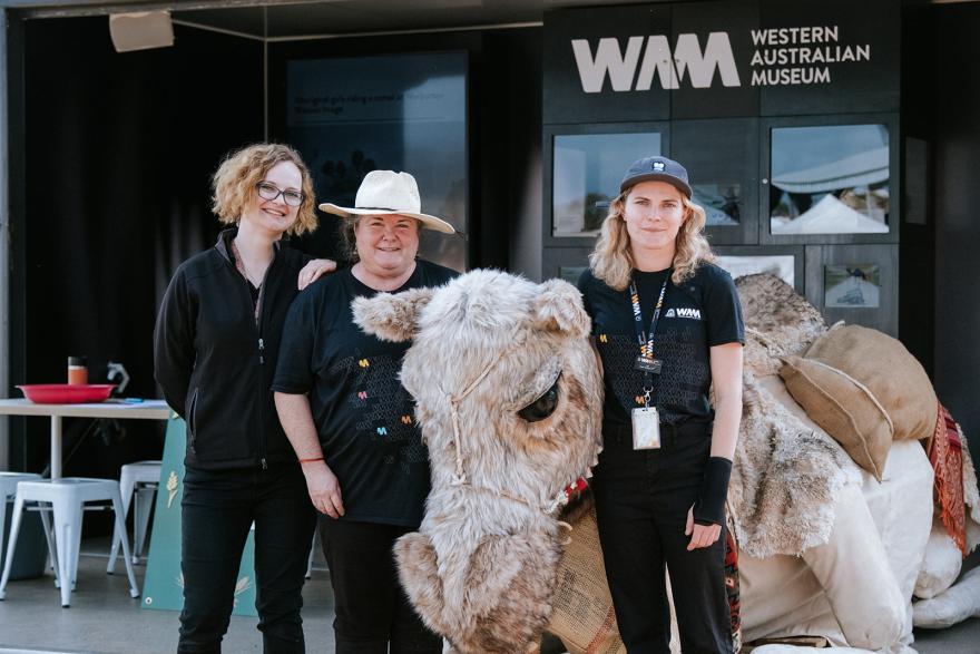 Three WA Museum staff with a lifesized camel puppet