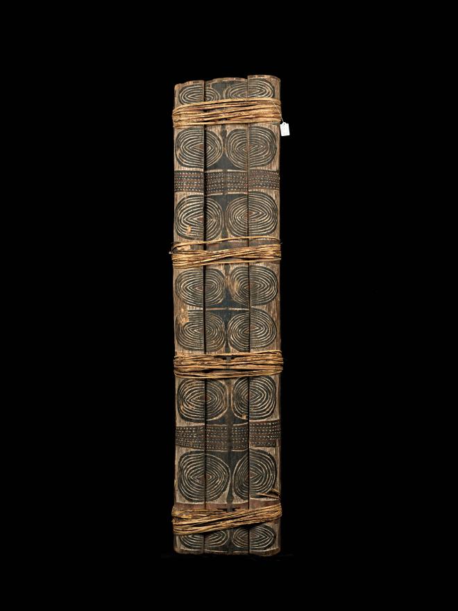 An intricately designed War shield, featuring three wooden logs tied together. From Arawe, West New Britain. Front View.