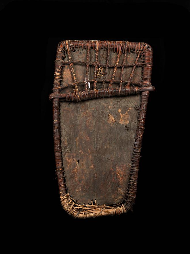 A Pig skin shield with a rattan Framework. Supposedly used by the younger initiate men. Back View.
