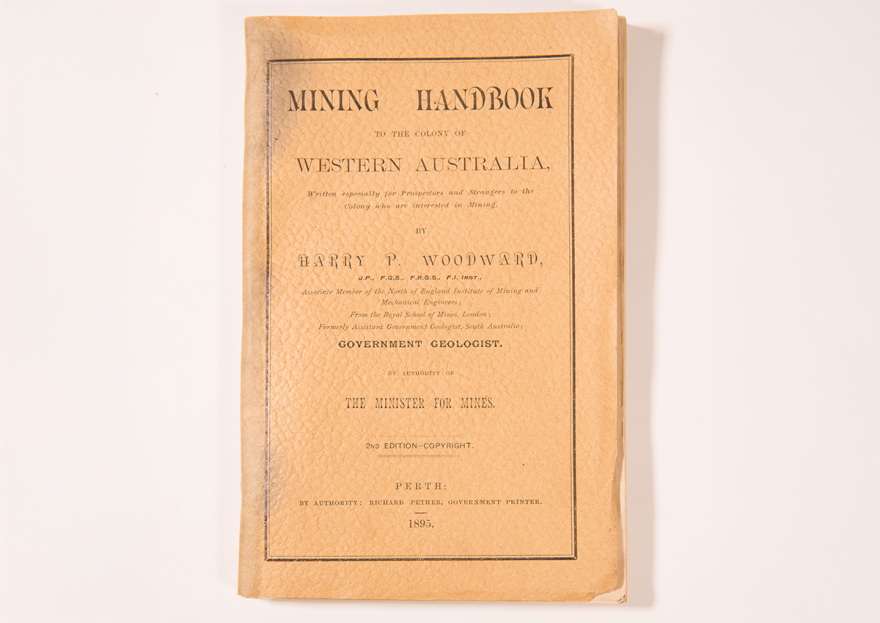 Photo of a light brown leather bound book labelled 'Mining Handbook Western Australia'