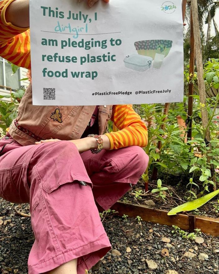 Person holding up a Plastic Free July pledge