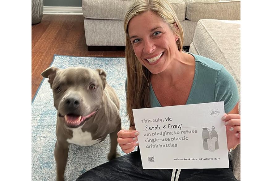 A person with a dog holding up a Plastic Free July pledge