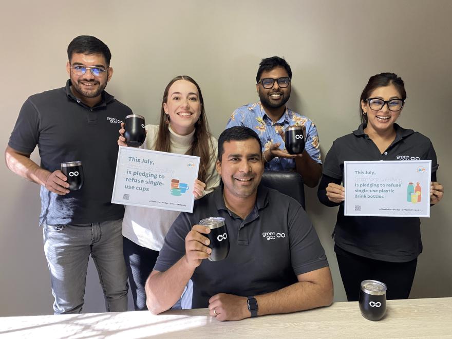 People holding up Plastic Free July pledges
